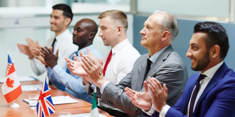 Satisfied leaders of several countries clapping their hands after report of colleague